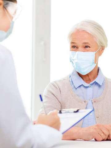 Older woman with nurse and clipboard